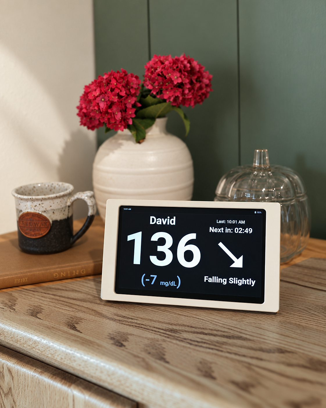 Beige Glucose Display showing a large glucose reading on its dark screen.