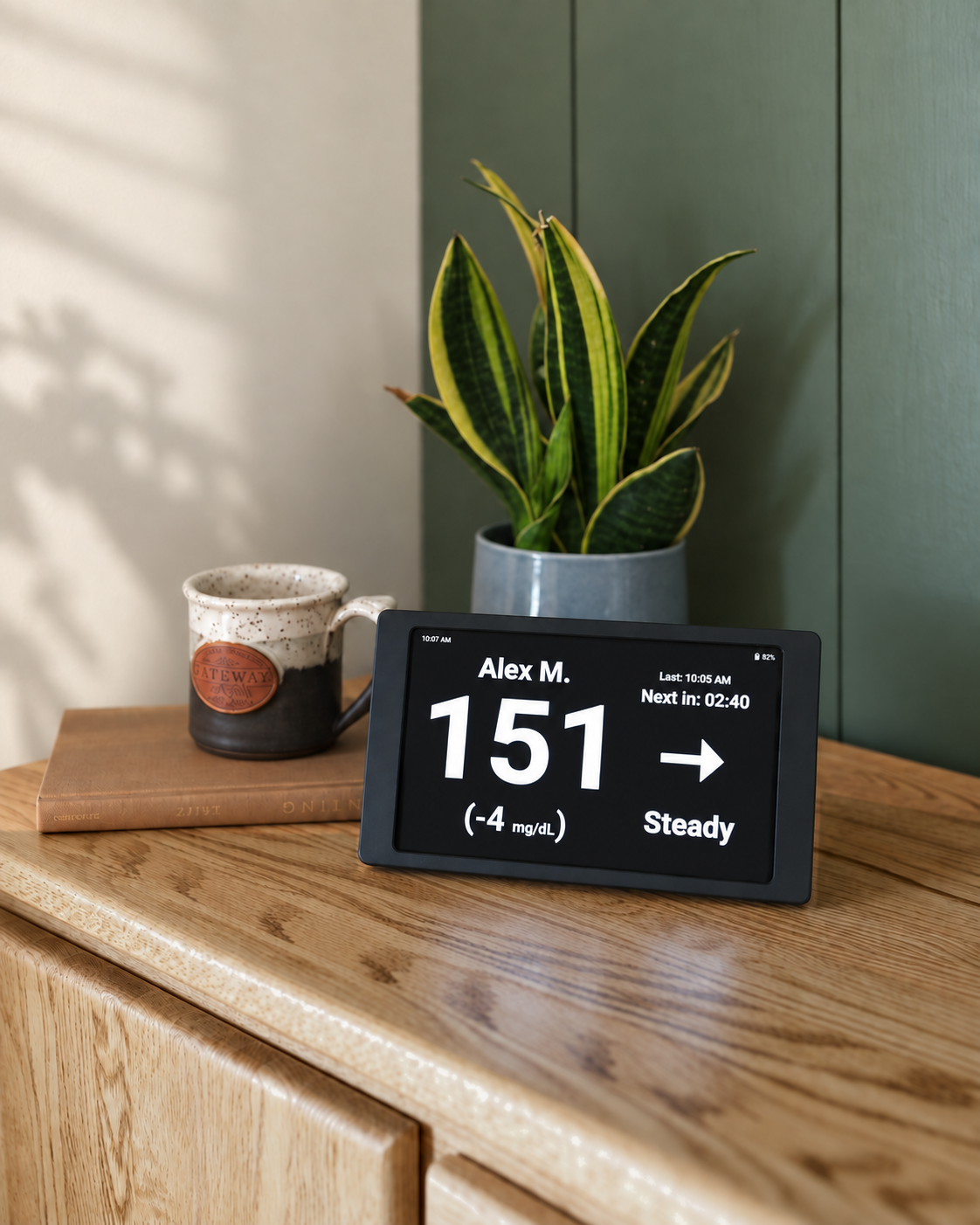 Black Glucose Display showing a large glucose reading and trend arrow on its dark screen.
